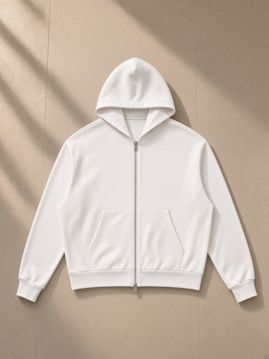 Drop Shoulder Full Zip Hoodie in White, laid flat on pale limestone