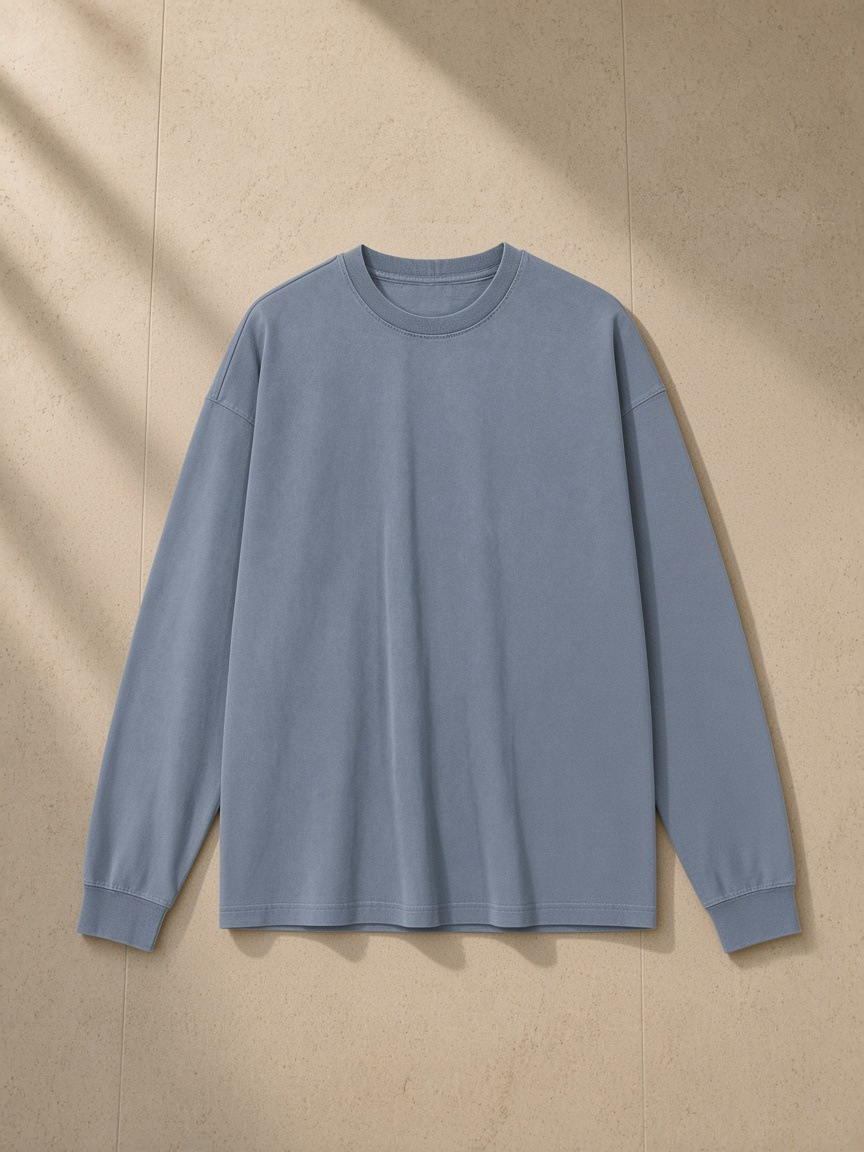 Vintage Washed Long Sleeve T-Shirt in Gray Blue, laid flat on pale limestone