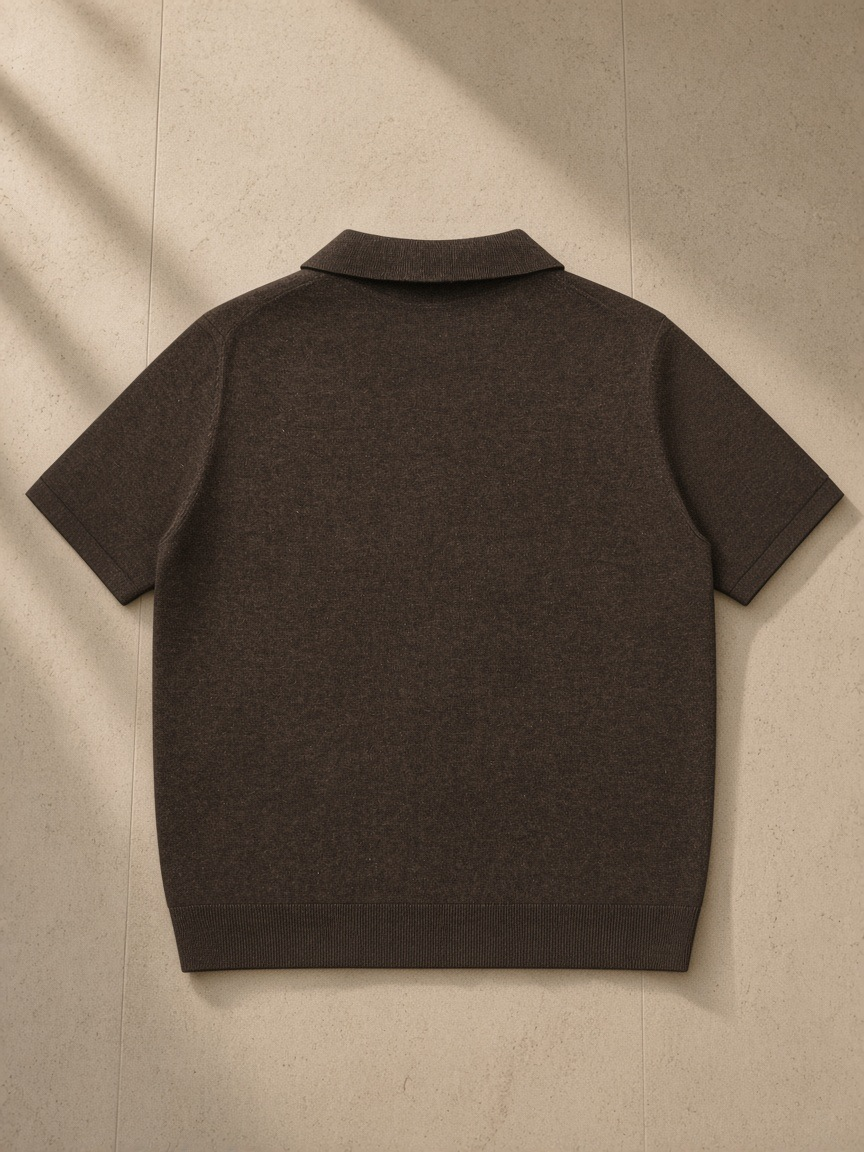 Heavyweight Oversized Polo in Dark Brown, laid flat on pale limestone, back view
