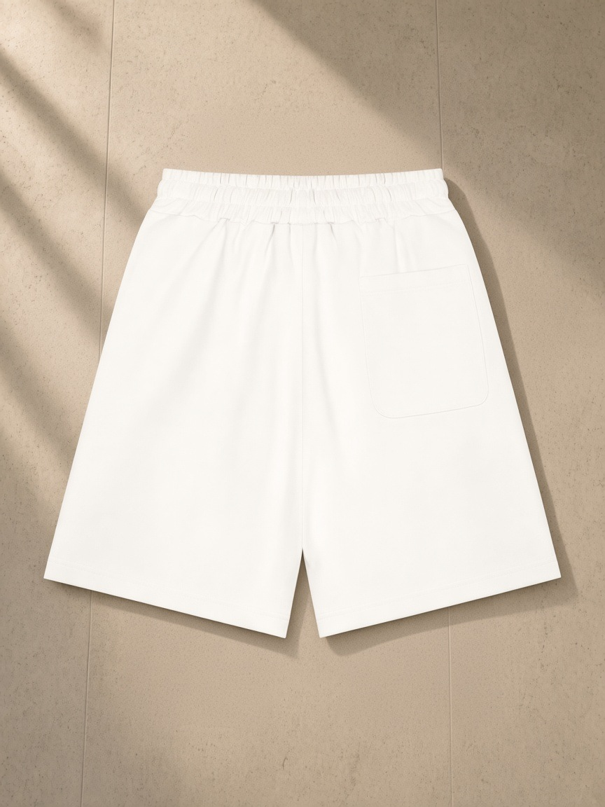 Heavyweight Shorts in White, laid flat on pale limestone, back.