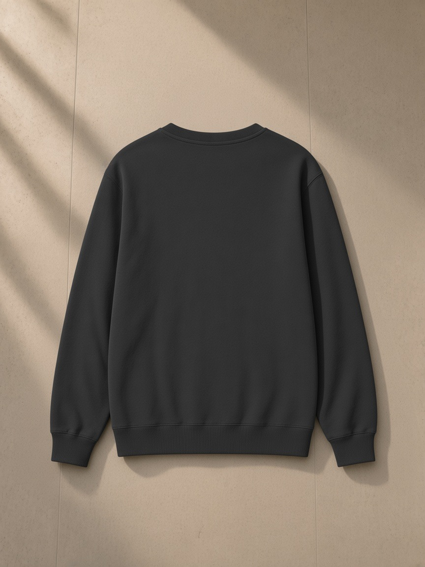 Classic Cotton Sweatshirt in Classic Black, laid flat on pale limestone, back view
