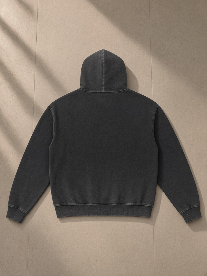 Vintage Washed Gradient Fleece Hoodie in Black, laid flat on pale limestone, back.