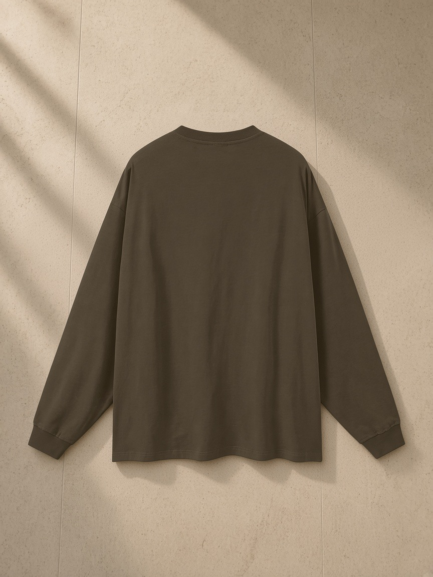 Oversized Long Sleeve T-Shirt in Brown, laid flat on pale limestone, back view