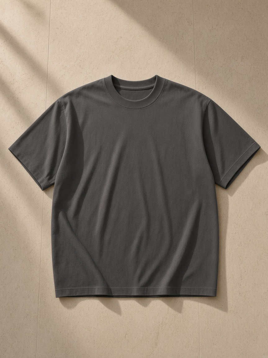 Unisex heavyweight drop shoulder cotton t-shirt in Dark Gray folded on a tatami bench in a Kyoto ryokan at night