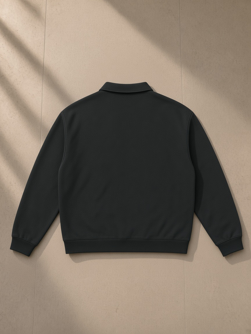 Oversized Collared Sweatshirt in Black, laid flat on pale limestone, back view
