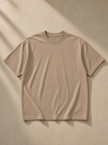 Enzyme Washed T-Shirt in Camel, laid flat on pale limestone