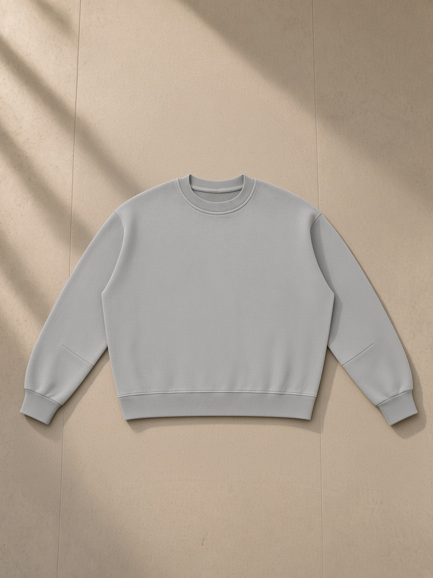 Boxy Vintage Washed Sweatshirt in Light Gray, laid flat on pale limestone