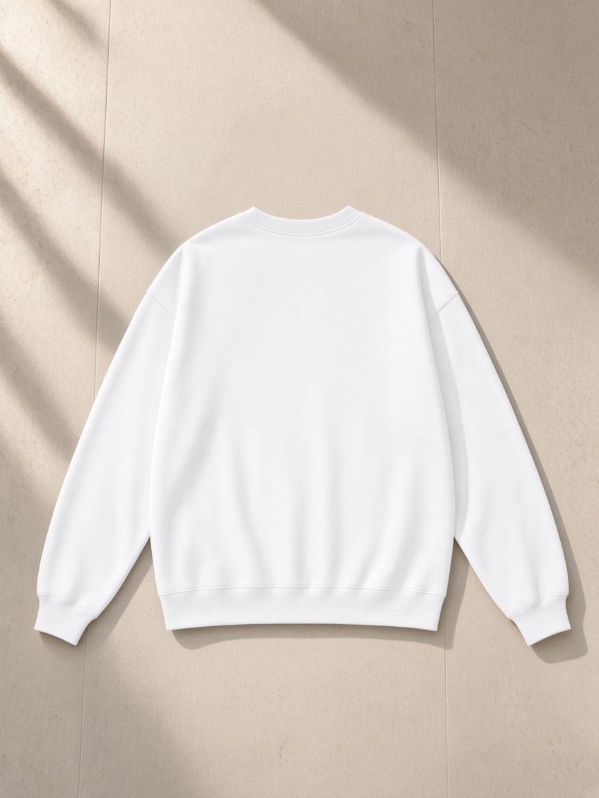 Heavyweight Drop Shoulder Sweatshirt in Lucent White, laid flat on pale limestone, back.