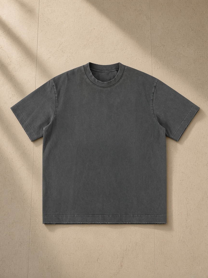 Women's heavyweight vintage washed frayed t-shirt in Dark Gray, laid flat on pale limestone
