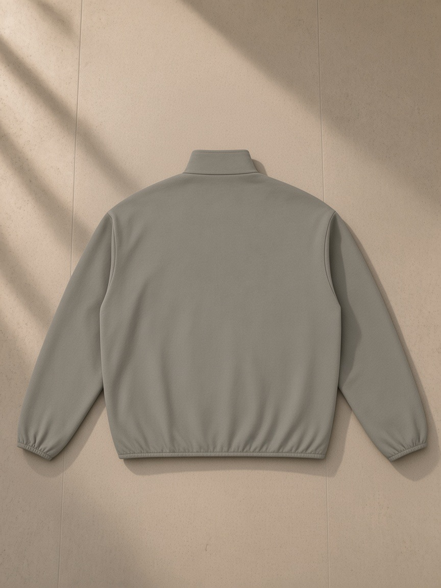 Essential Heavyweight Stand Collar Jacket in Army Green, laid flat on pale limestone, back view
