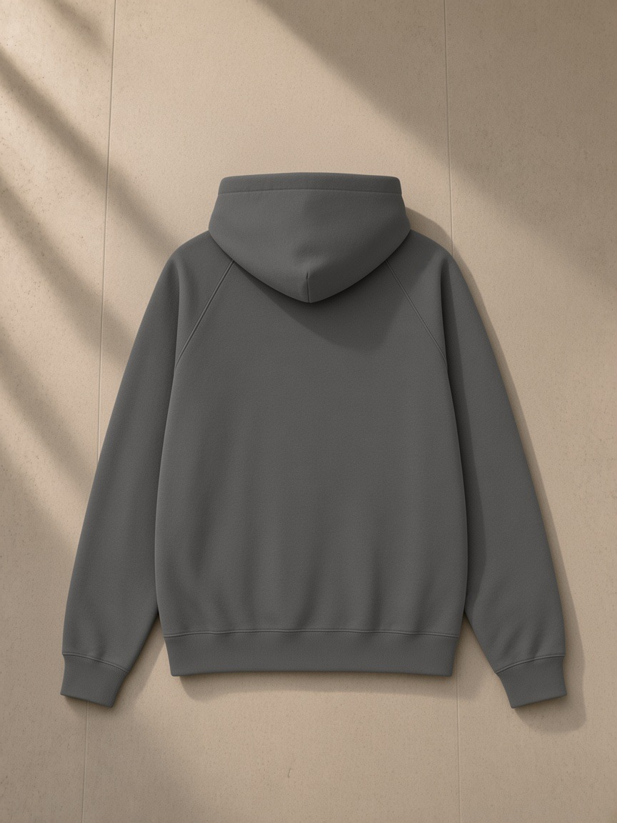 Essential Raglan Sleeve Fleece Hoodie in Cement Gray, laid flat on pale limestone, back view