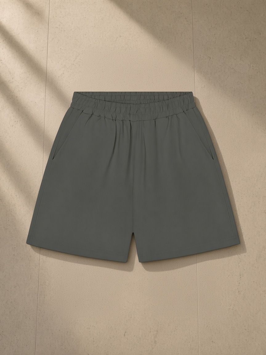 Unisex regular fit shorts in Dark Gray, laid flat on pale limestone