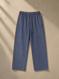 Snow Washed Straight Leg Pants in Blue, laid flat on pale limestone