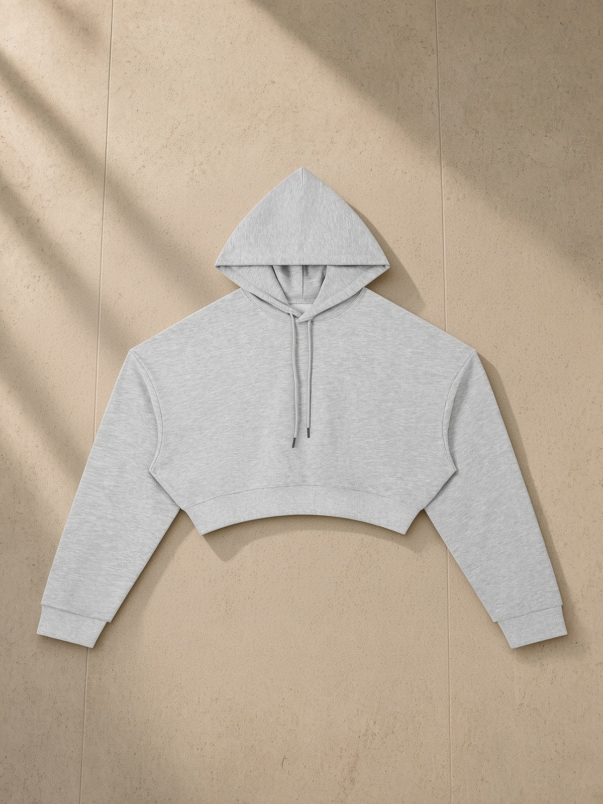 Essential Cropped Hoodie in Flower Gray, laid flat on pale limestone