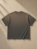 Women's sun fade raw edge t-shirt in Dark Gray, laid flat on pale limestone