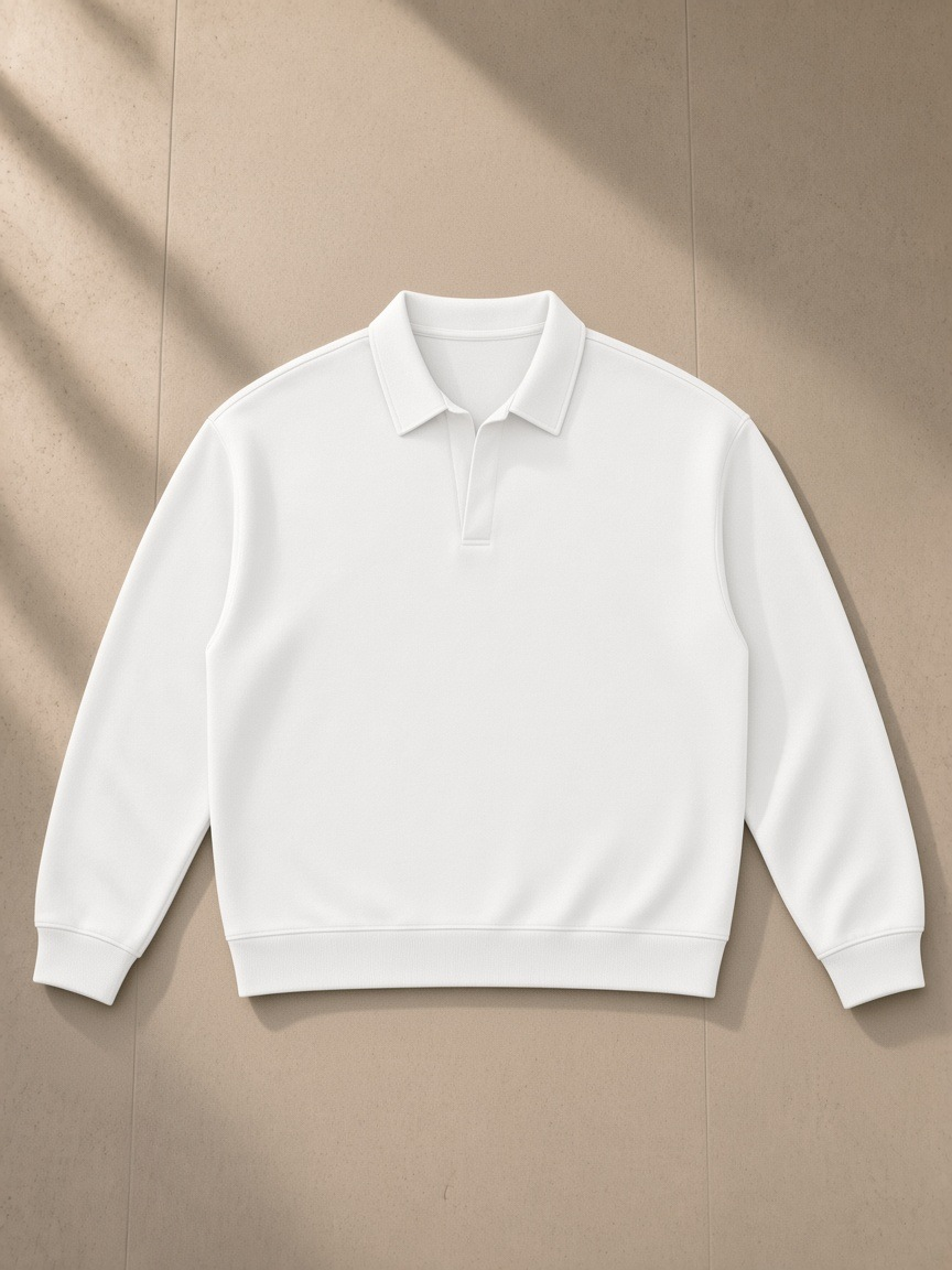 Oversized Collared Sweatshirt in White, laid flat on pale limestone