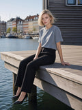 Woman in the Enzyme Washed T-Shirt in Gray Blue on a harbour deck in Copenhagen in the morning