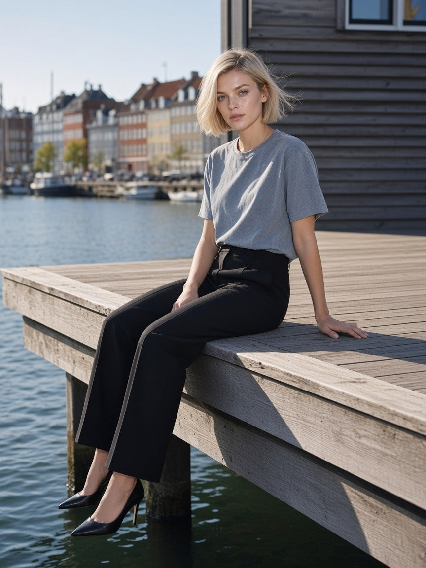 Woman in the Enzyme Washed T-Shirt in Gray Blue on a harbour deck in Copenhagen in the morning