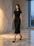 Woman in the Essential Bodycon Crewneck T-Shirt in Black in a marble hotel lobby in Seoul at dawn