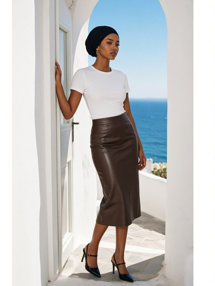 Woman in the Essential Bodycon Crewneck T-Shirt in White standing on a whitewashed terrace in Mykonos in the morning