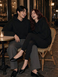 Two people in the Essential Boxy Darted Sleeve Hoodie in Black at a Paris cafe table at night