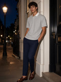 Man in the Essential Contrast Polo Shirt in Flower Gray leaning in a Mayfair mews in London at night