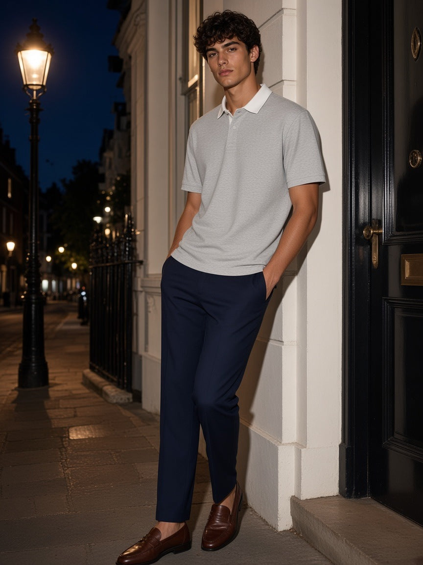 Man in the Essential Contrast Polo Shirt in Flower Gray leaning in a Mayfair mews in London at night