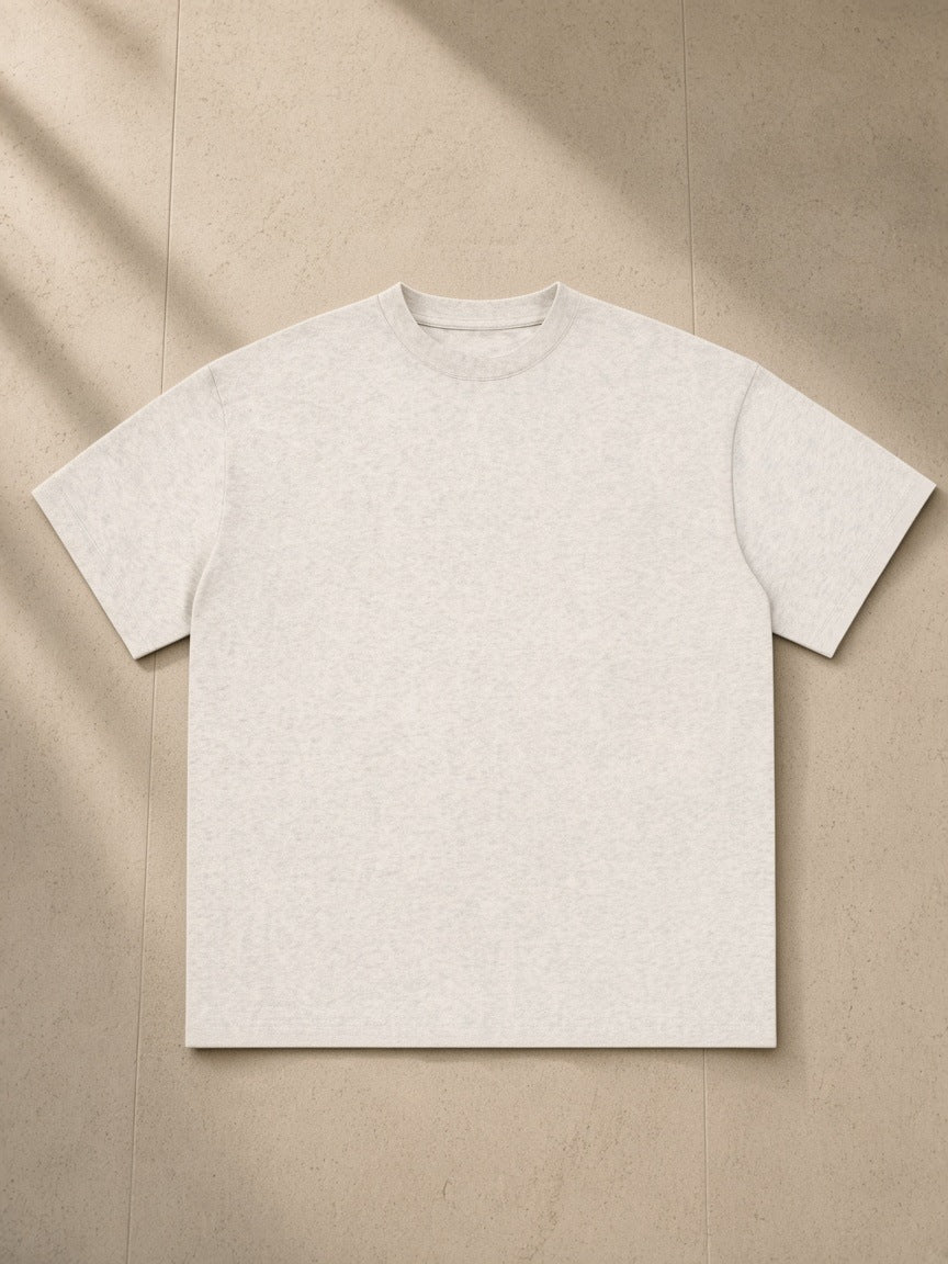 Essential Cotton T-Shirt, 260 gsm, Drop Shoulder in Oat Gray, laid flat on pale limestone