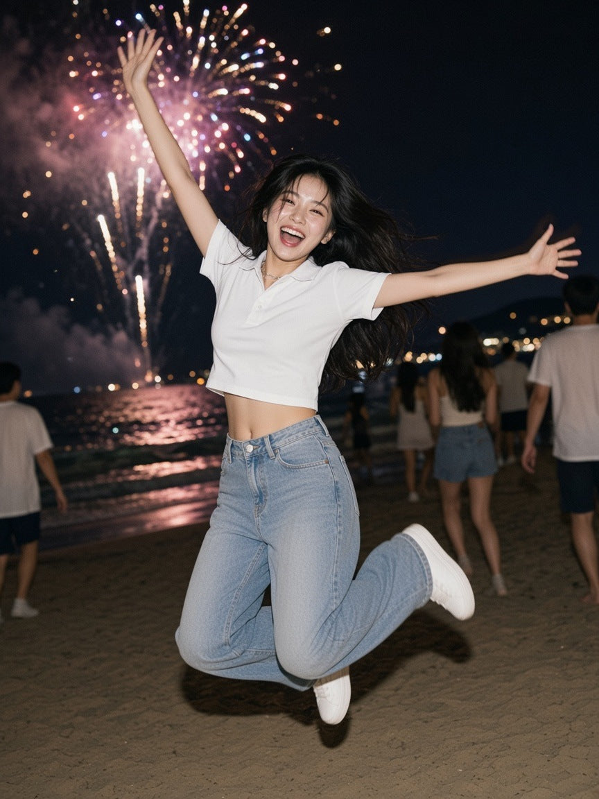 Woman in the Essential Cropped Polo Shirt in White, jumping under fireworks on a Busan beach at 1am