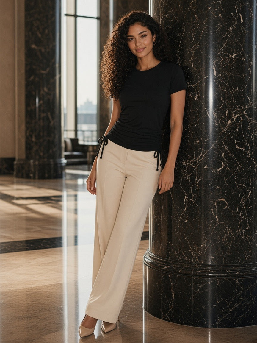 Woman in the Essential Drawstring T-Shirt in Black standing in a marble hotel lobby on the Upper East Side, New York in the morning
