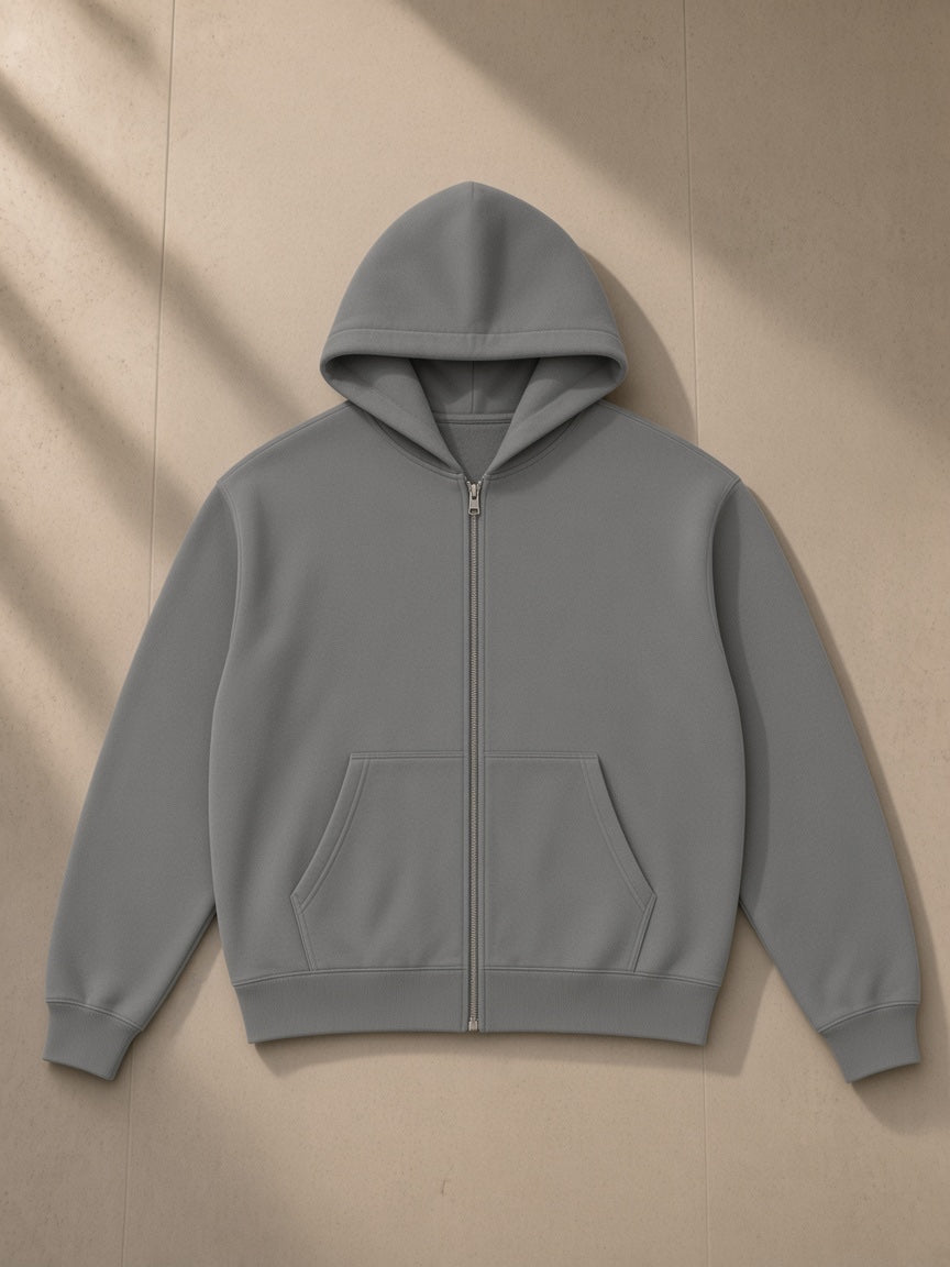 Essential fleece zip-through hoodie in Medium Gray, laid flat on pale limestone, front view