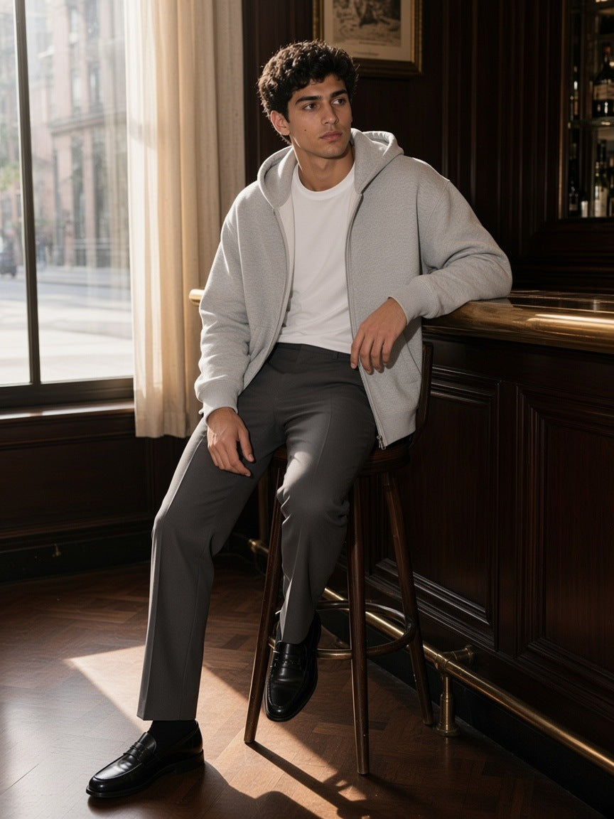 Man in the Essential Fleece Zip-Through Hoodie in Flower Gray in a hotel bar in New York by day