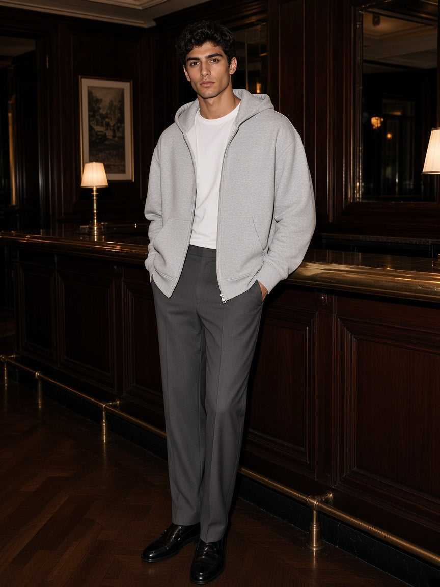 Man in the Essential Fleece Zip-Through Hoodie in Flower Gray in a hotel bar in New York at night