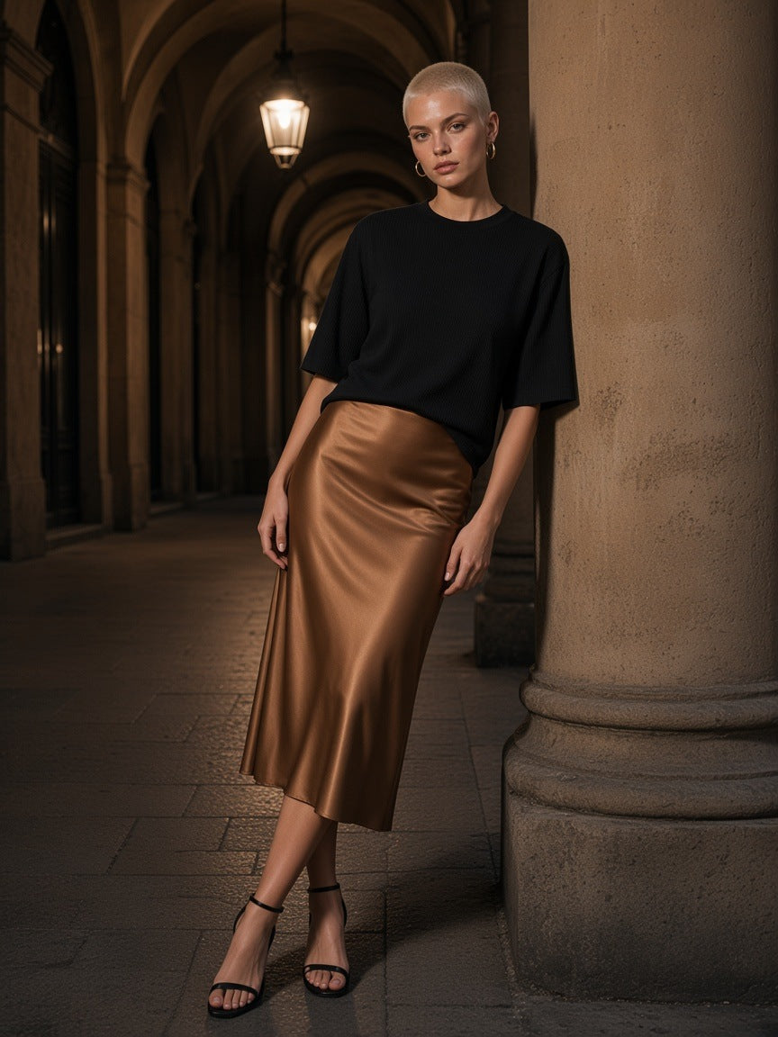 Woman in the Essential Half Sleeve Ribbed T-Shirt in Black and a satin midi skirt under the porticoes in Bologna at night