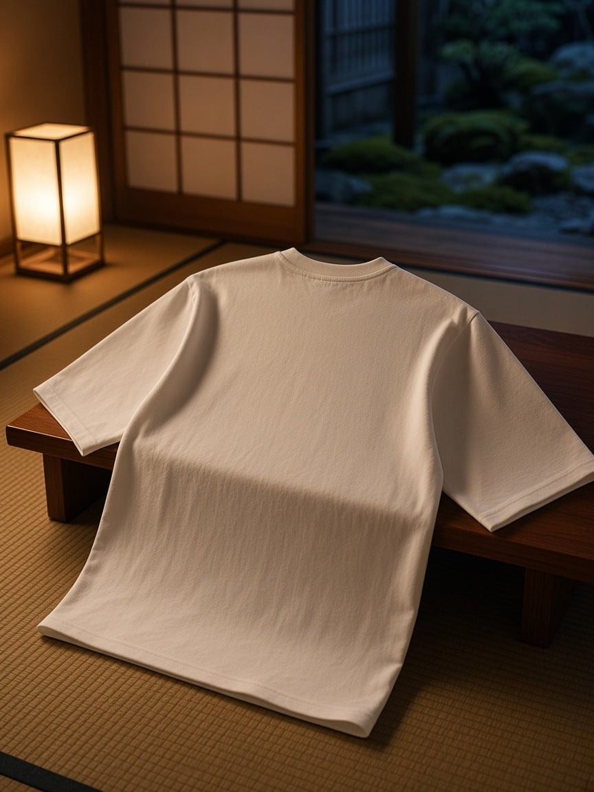 Essential Half Sleeve Ribbed T-Shirt in White draped over a low wooden bench in a Kyoto ryokan at night