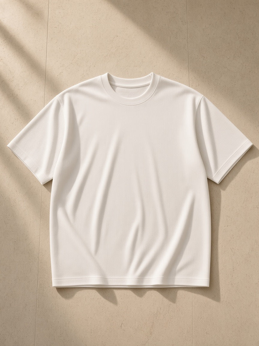 Essential Half Sleeve Ribbed T-Shirt in White, laid flat on pale limestone