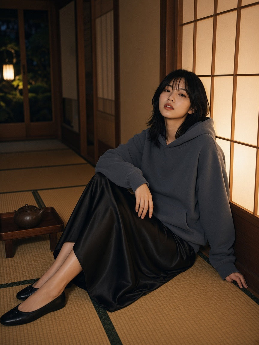 Woman in the Marcel Afters Essential Heavyweight Boxy Fleece Hoodie in Gray Blue in a ryokan hotel corridor at night in Kyoto