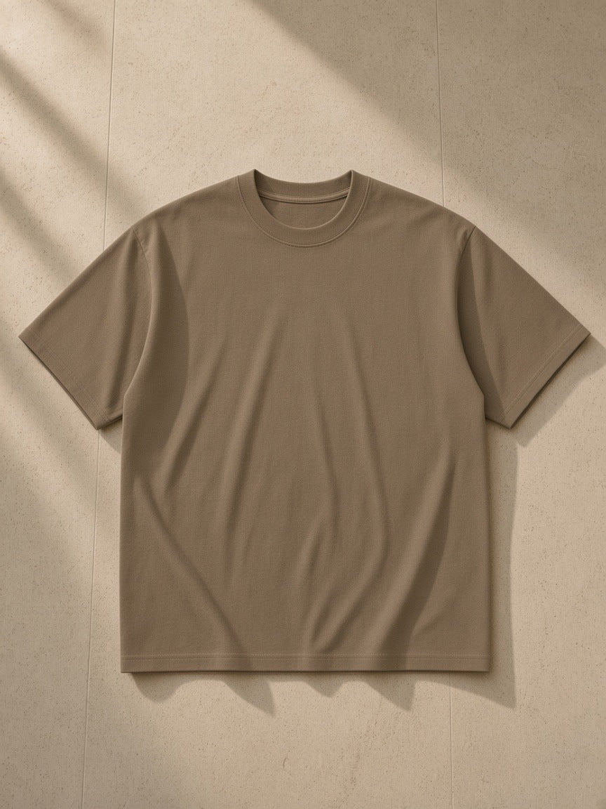Women's Essential Heavyweight Cotton T-Shirt in Coffee, laid flat on pale limestone