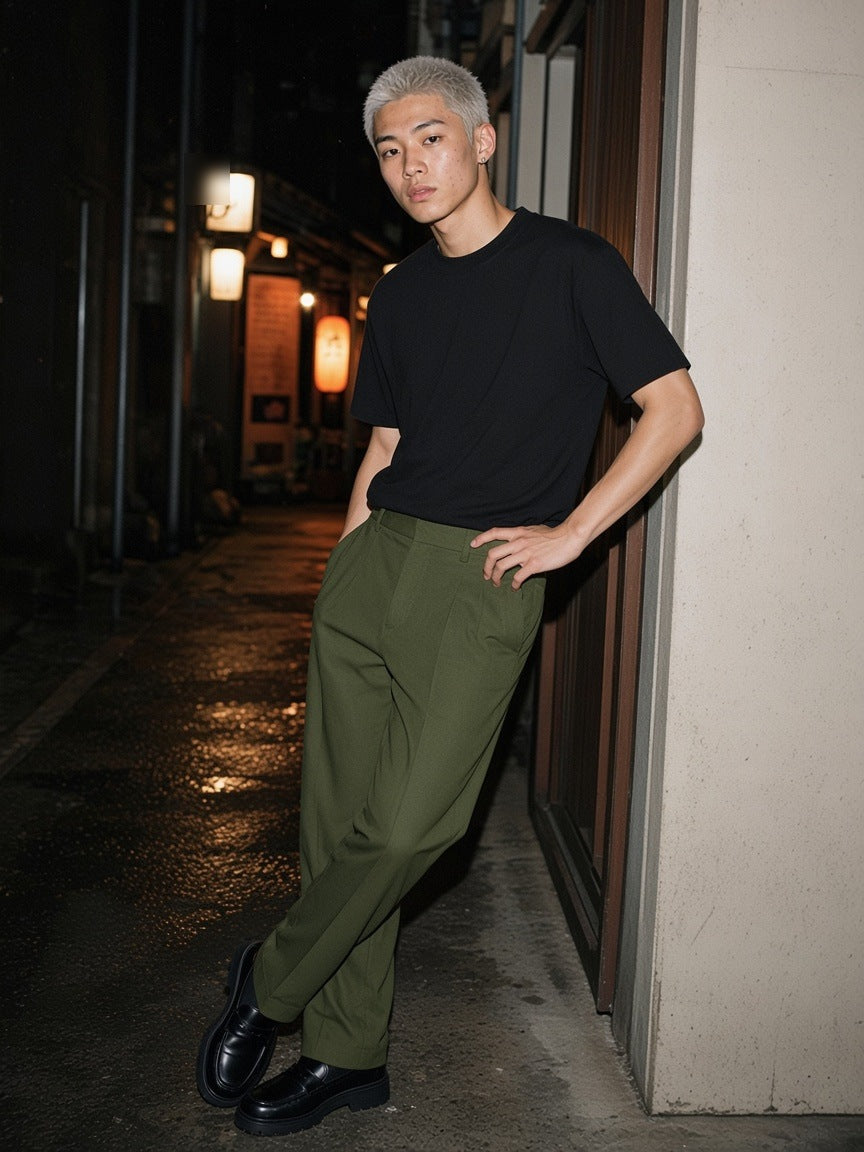 Man in the Essential Heavyweight Cotton T-Shirt in Black leaning in a doorway in Golden Gai, Tokyo at night