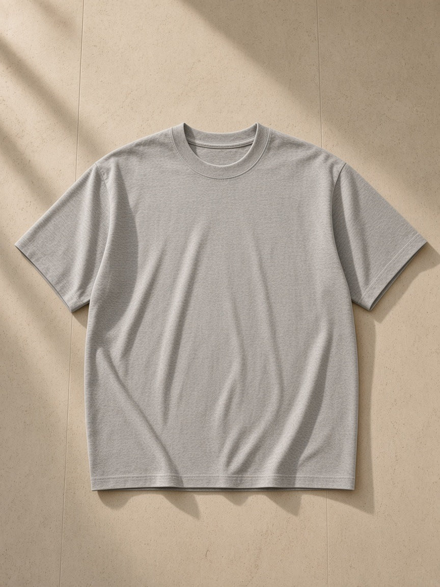 Women's Essential Heavyweight Cotton T-Shirt in Flower Gray, laid flat on pale limestone