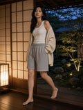 Woman in the Essential Heavyweight Fleece Shorts in Flower Gray on the veranda of a ryokan in Kyoto at blue hour