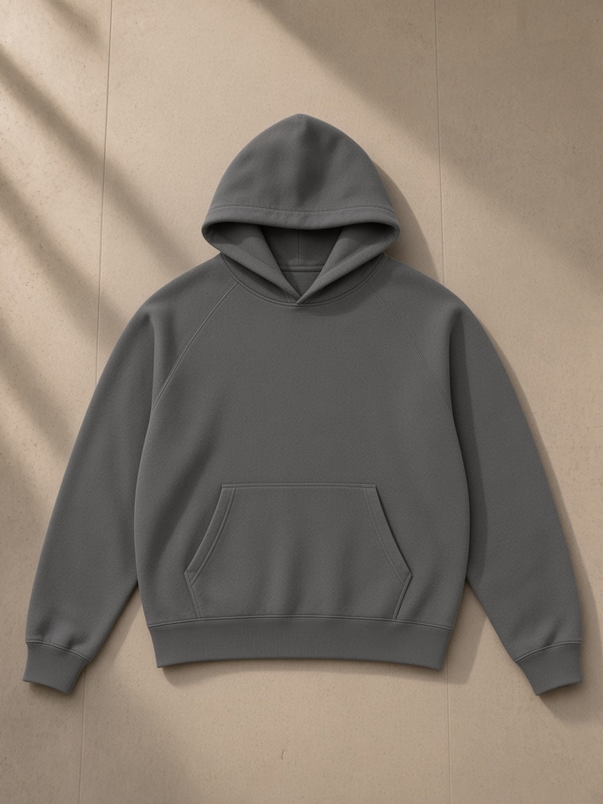 Essential Raglan Sleeve Fleece Hoodie in Cement Gray, laid flat on pale limestone, front view
