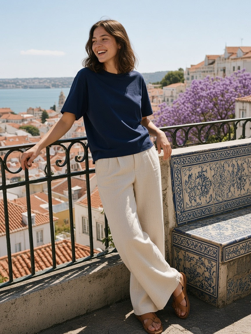 Woman in the Essential Sorona Boxy T-Shirt in Navy Blue at a miradouro rail above Lisbon in the morning