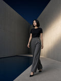 Woman in the Essential Standard Shoulder T-Shirt in Black in a concrete courtyard in Tokyo at night