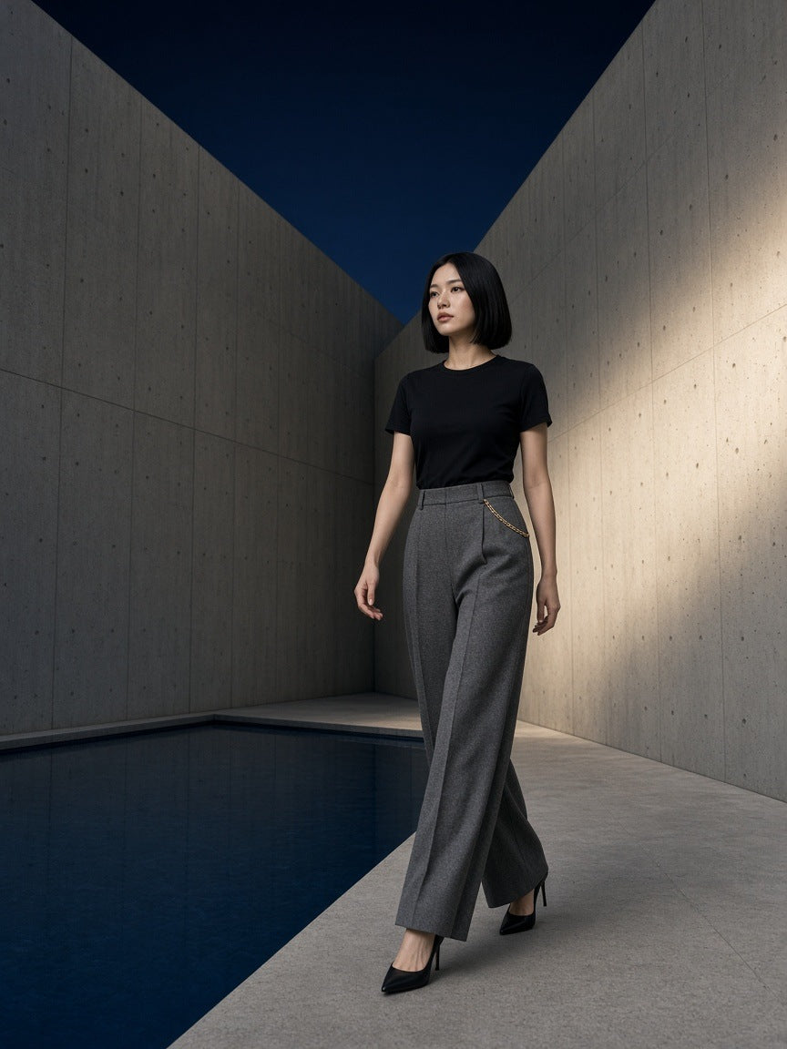 Woman in the Essential Standard Shoulder T-Shirt in Black in a concrete courtyard in Tokyo at night