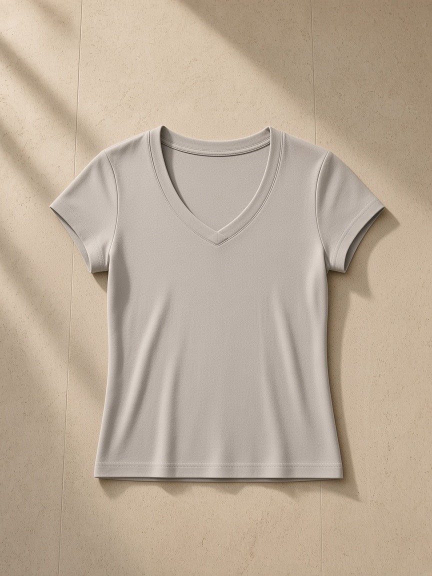 Essential V-Neck Bodycon T-Shirt in Light Gray, laid flat on pale limestone