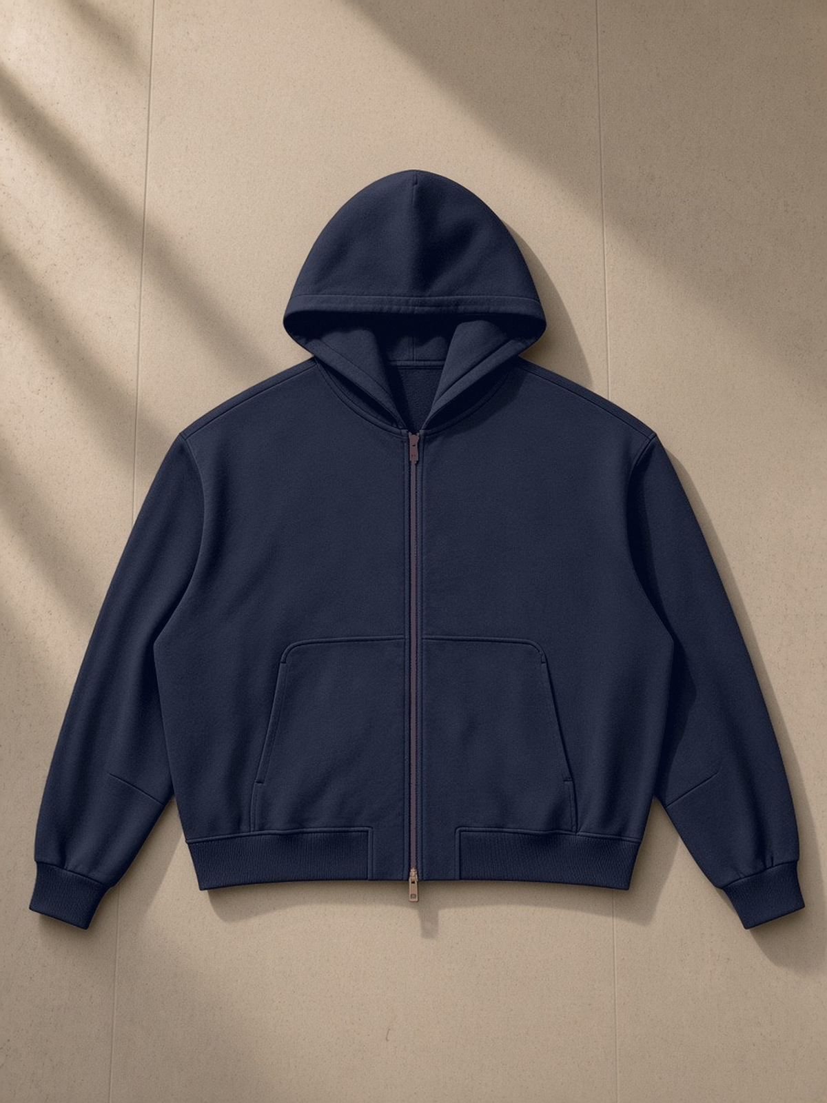 Vintage Wash Boxy Full Zip Hoodie in Navy Blue, laid flat on pale limestone, front view