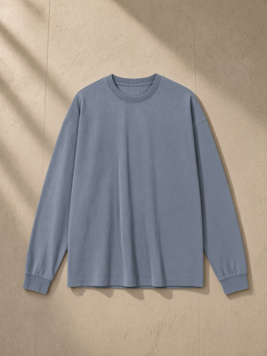 Vintage Washed Long Sleeve T-Shirt in Gray Blue, laid flat on pale limestone, back.