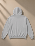 Unisex heavyweight zip-up hoodie in Flower Gray, laid flat on pale limestone, back view