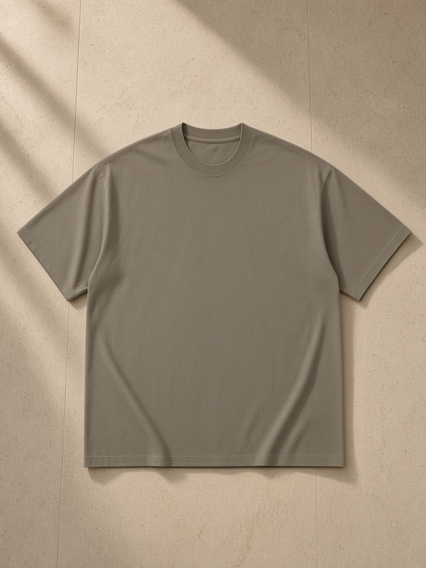 Heavyweight Loose Fit T-Shirt in Gray Coffee, laid flat on pale limestone